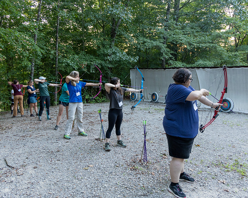 Students firing bows in an archery course