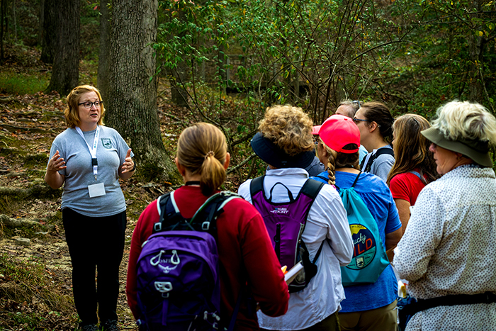 Megan O. teaching a group of people in a woods