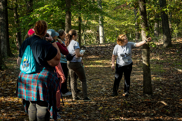 Megan O. teaching a group of people in a woods