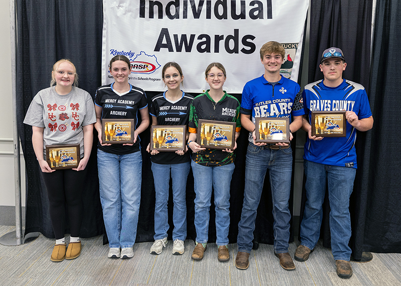 six Students holding up placards in front of a sign that reads individual award