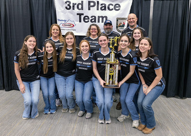 A group of eight students and four adults in front of a sign that reads 3rd place team