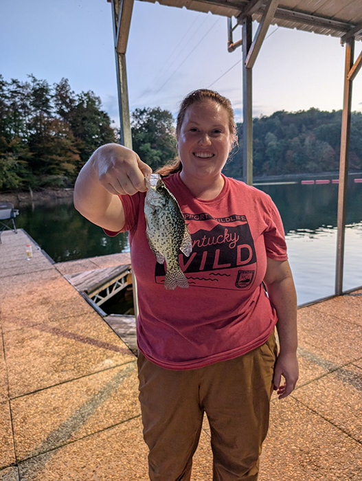 Ashley R holding up a small sunfish