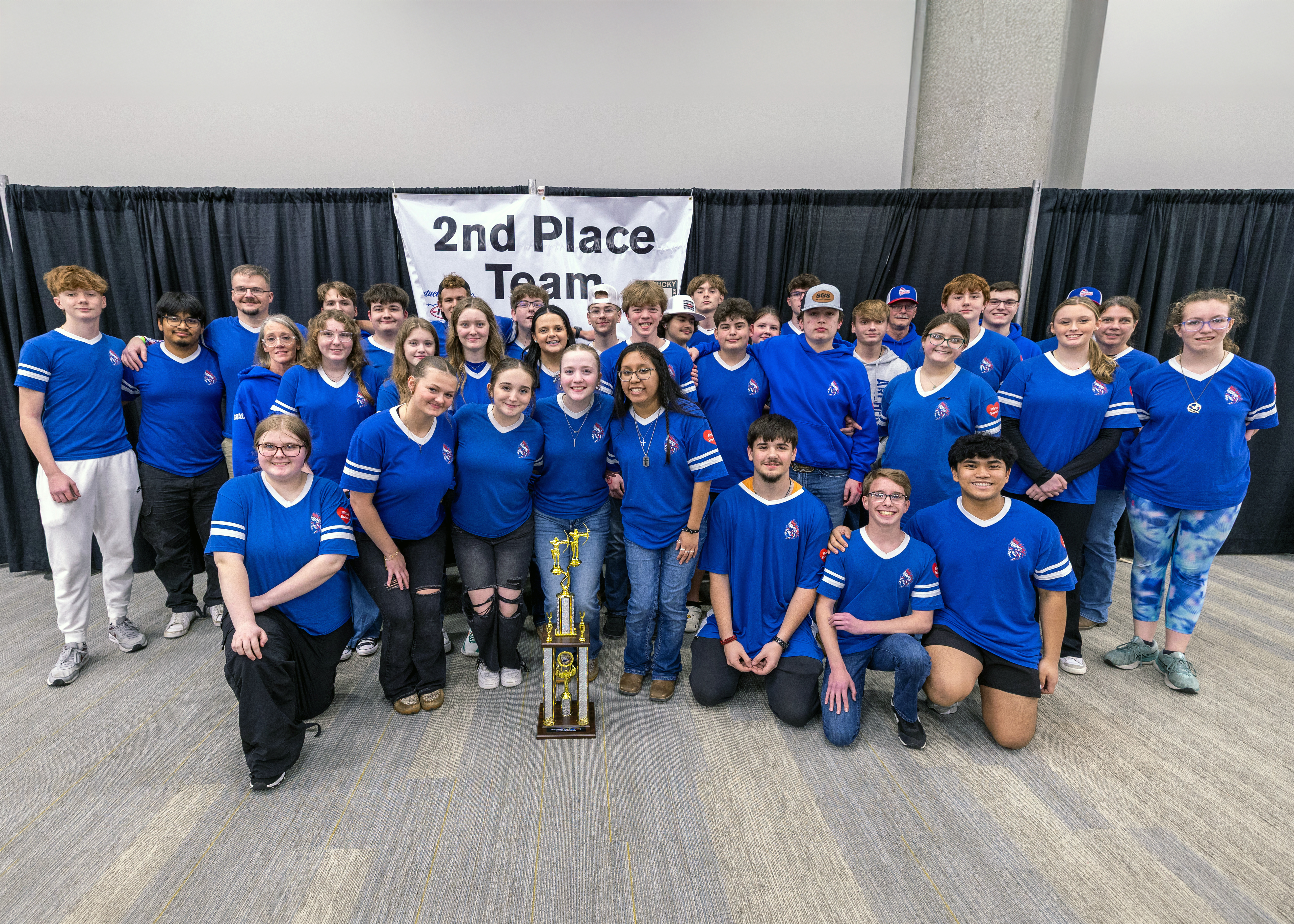 A group of massive groups of students and adults in front of a sign that reads 2nd place team