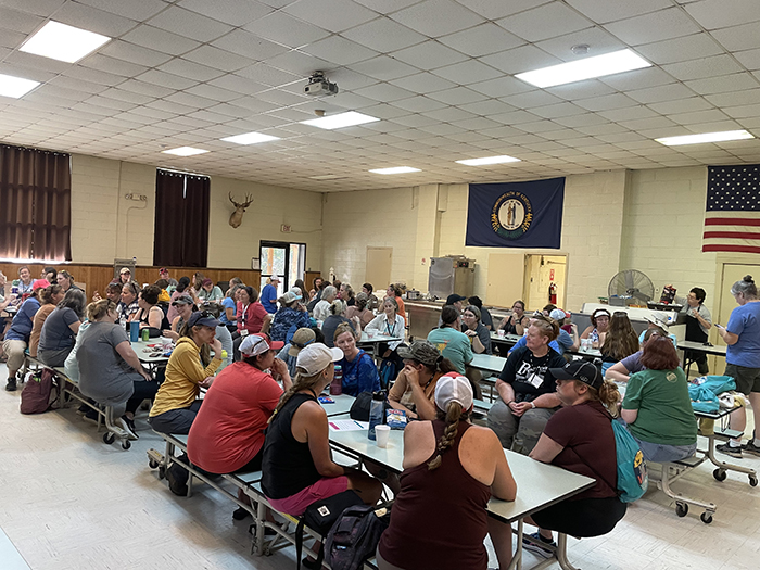 a group of people filling a cafeteria