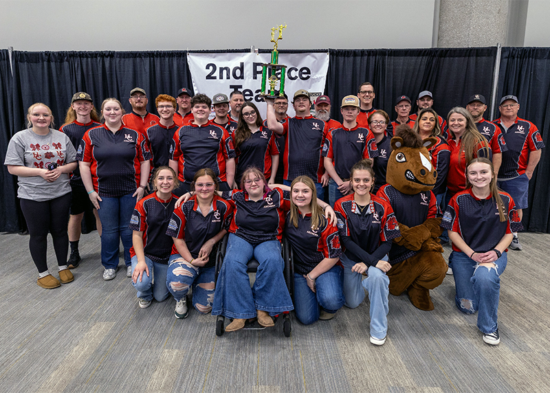 tA massive group of students and adults in front of a sign that reads 2nd place team
