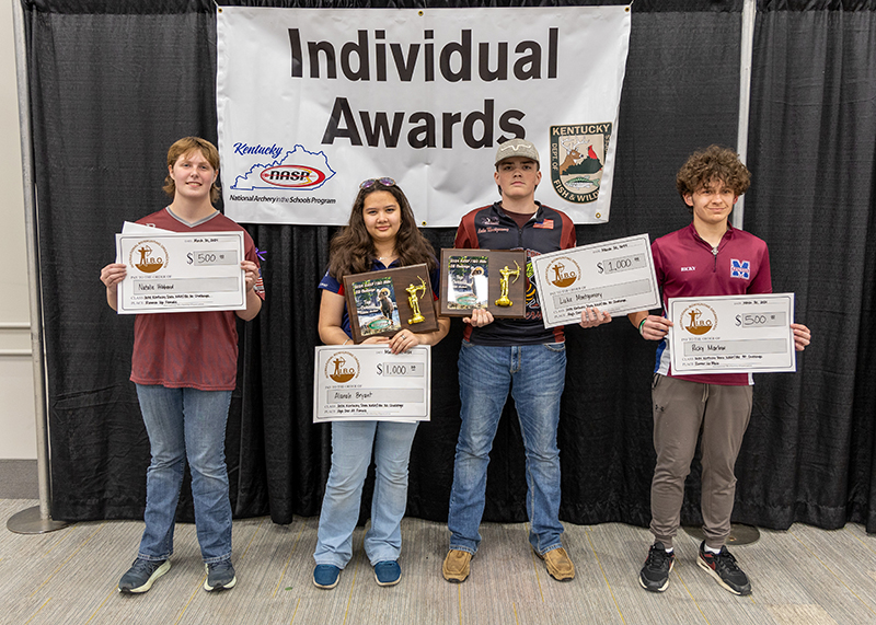 four students holding up award plaques in front of a sign that reads individual awards