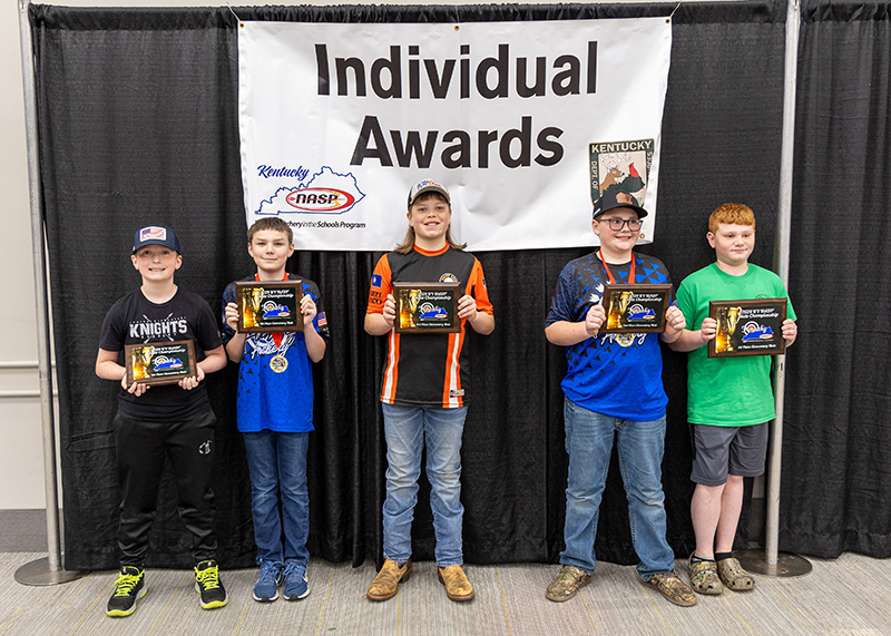 a group of students holding up plaques with a sign behind them reading individual awards