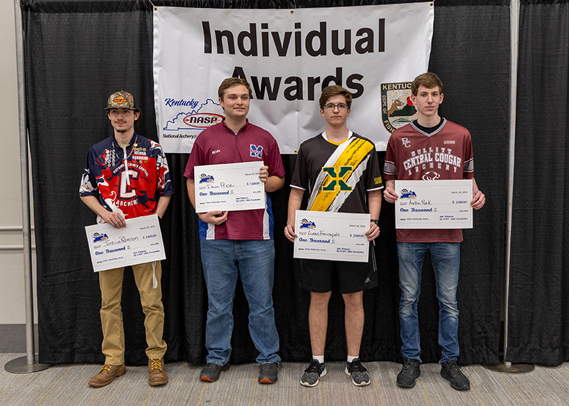 a group of students holding up plaques with a sign behind them reading individual awards