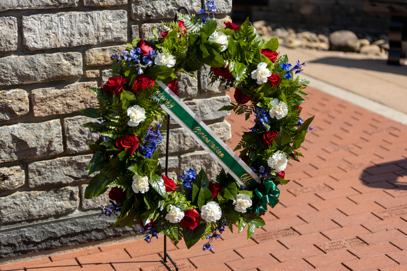 A floral wreath with a ribbon that reads Kentucky Conservation Officers