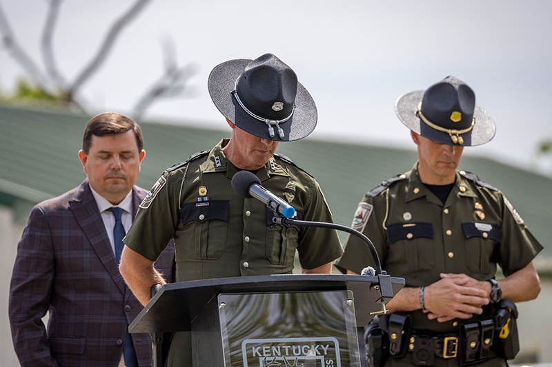 Four Conservation officers are walking in a procession