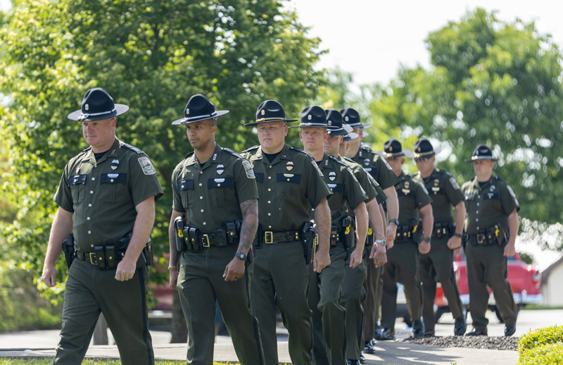 A procession of conservation officers walking in a line