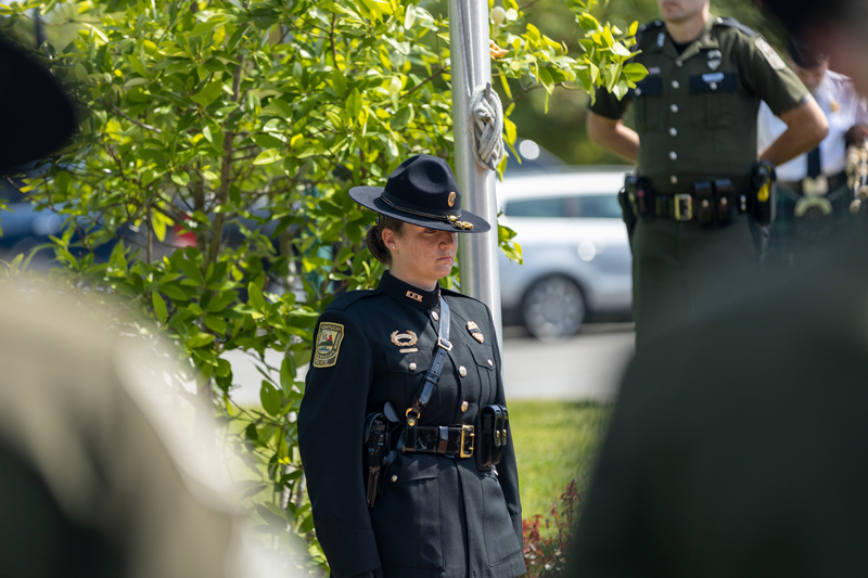 A female color guard officer stands at attention