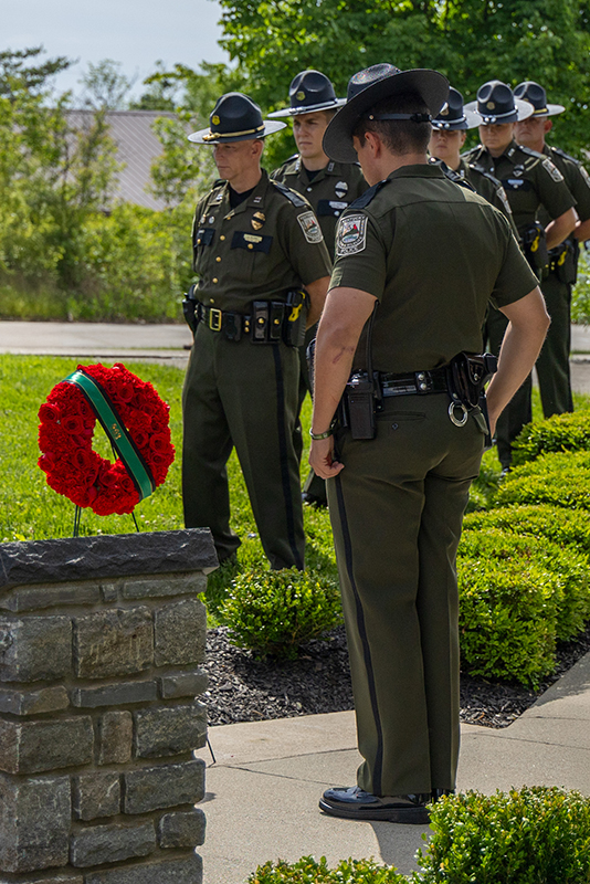 A man and woman are looking at memorial markers