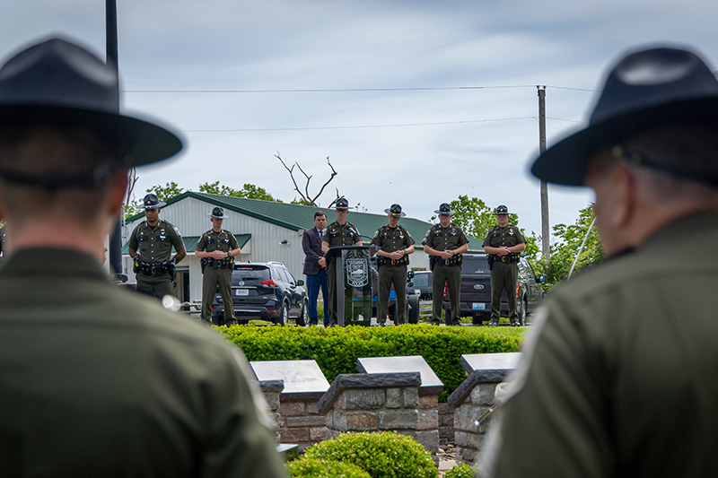 Four officers are standing in prayer in the center of the memorial