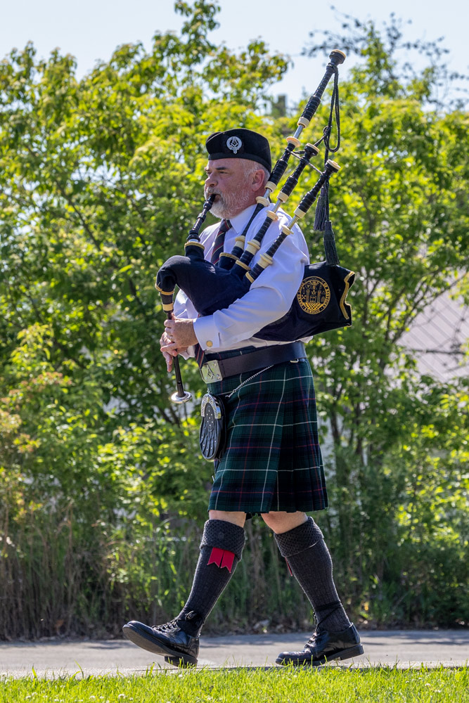 A bagpiper leads a procession