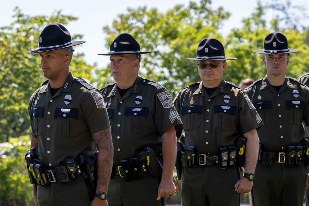 Four Conservation officers are walking in a procession