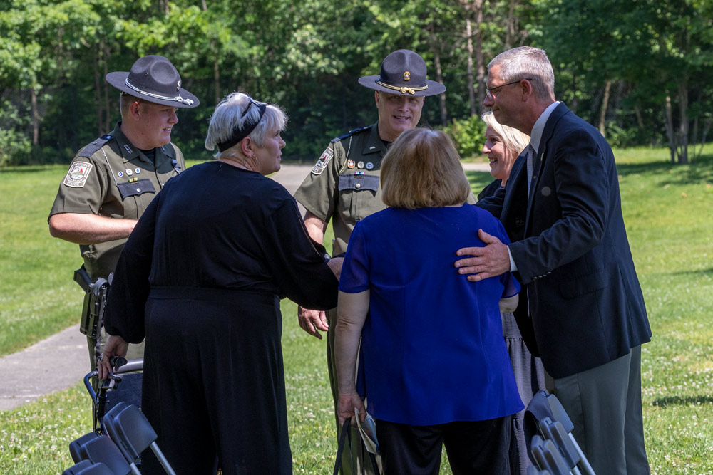 Deputy Commissioner Clark is standing with a group fo two officers and three women