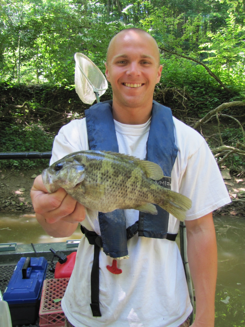 Cory Woosley holds a 9.5 inch rock bass collected and released during a sport fish survey.