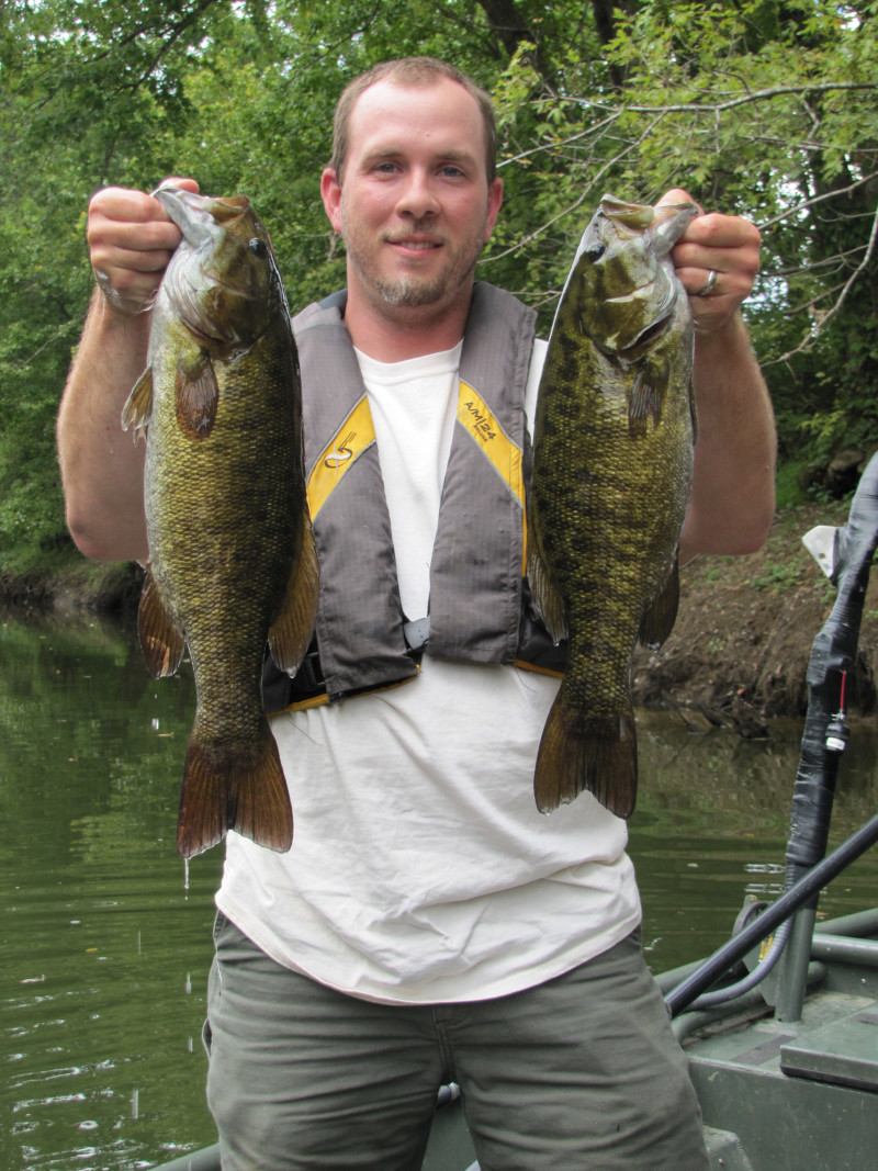 Biologist David Baker holds two smallmouth bass captured and released from the Barren River