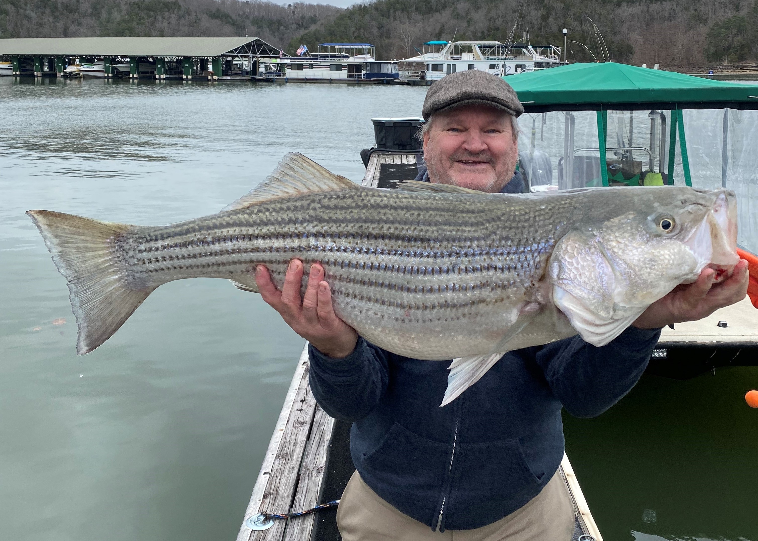 Tim Healey holding up a Trophy sized striped bass