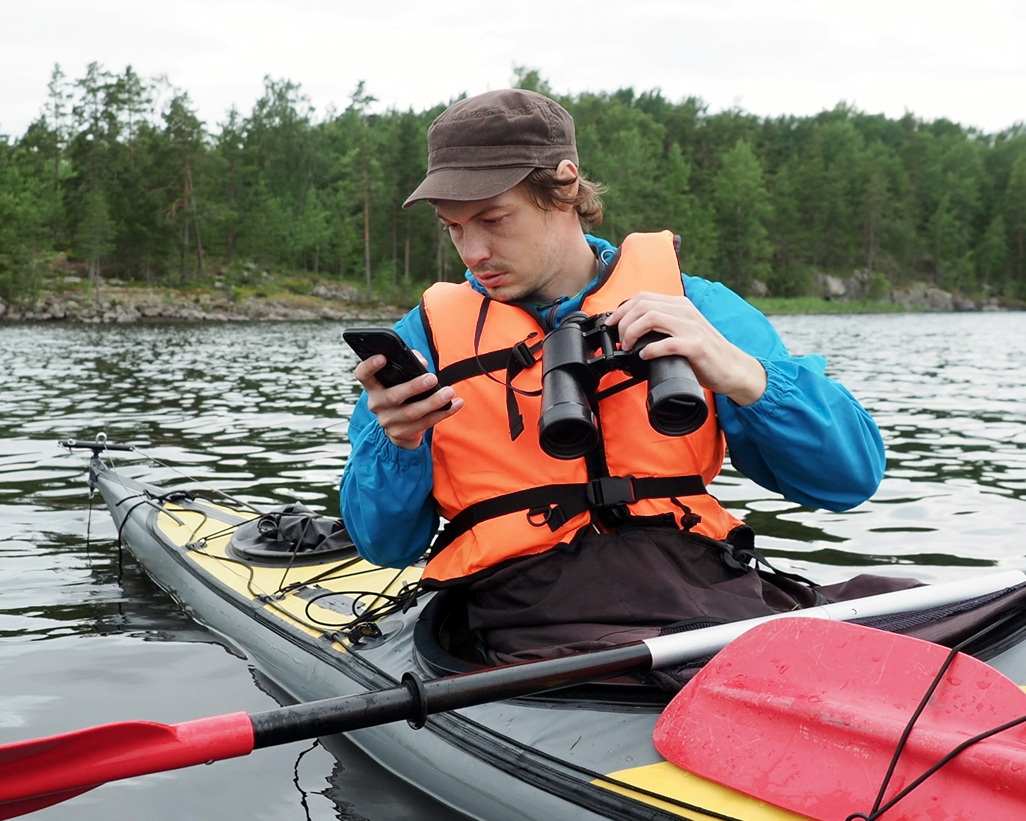 Person holding a phone in a kayak