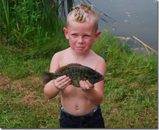The young angler pictured caught this 12-inch “trophy” sunfish at Meadowview Lake in Spencer County.