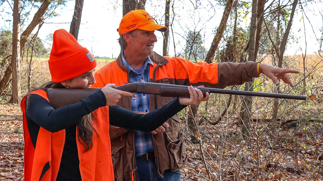 Hunter showing another hunter how to shoot