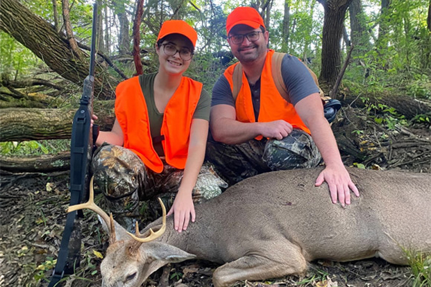 Mentor and Mentee celebrating hunting a deer