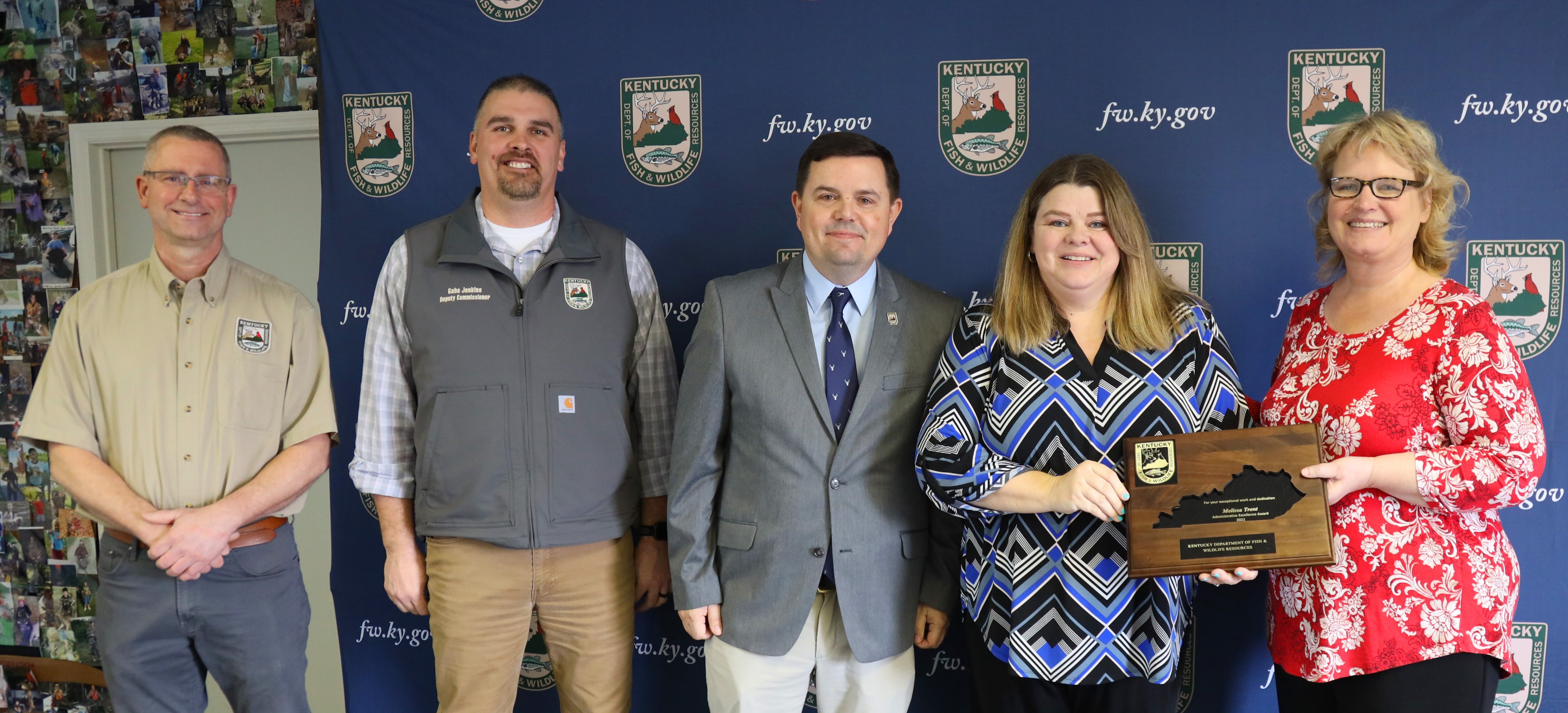 Photograph showing a group of three men and two women smiling for the camera. Pictured left to right, Deputy Commissioners Brian Clark and Gabe Jenkins, Commissioner Rich Storm, Melissa Trent, Administrative Services Division Director Lisa Cox.