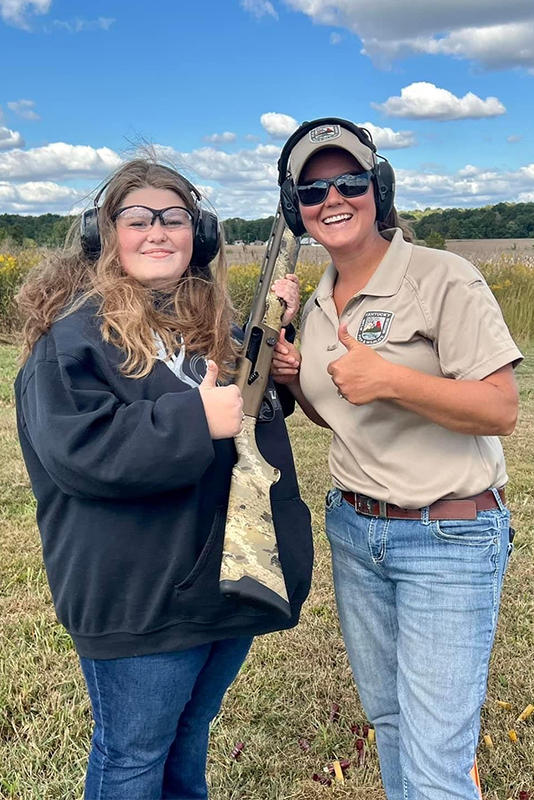 Goodman (right) works with a student during a range day event in Muhlenberg County.