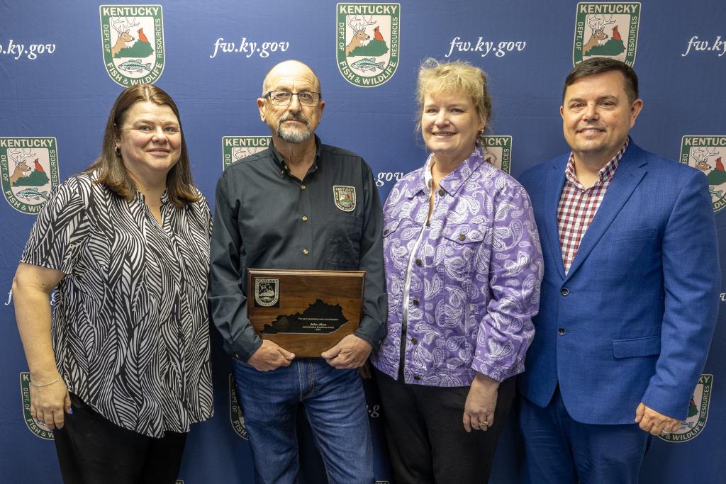 Pictured left to right Assistant Director of Administrative Services Melissa Trent, John Akers, Administrative Services Division Director Lisa Cox, and Commissioner Rich Storm