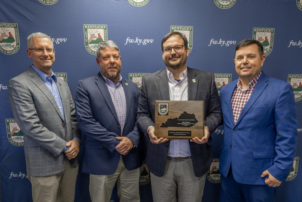 Pictured left to right Deputy Commissioner Brian Clark, Engineering, Infrastructure and Technology Division Acting Director Kevin Rexroat, John Roberts, and Commissioner Rich Storm.