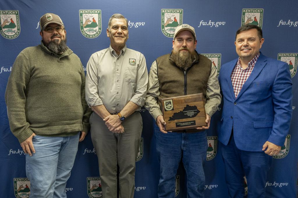 Pictured left to right Fisheries Division Assistant Director Josh Pennington, Fisheries Division Director Dave Dreves, Caleb Bentley, and Commissioner Rich Storm.