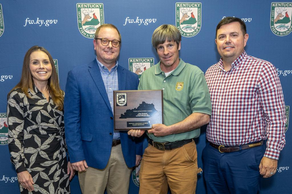 Pictured left to right Information and Education Division Assistant Director Emily Hogue, Information and Education Division Director Kevin Kelly, Clay Brummal, and Commissioner Rich Storm.