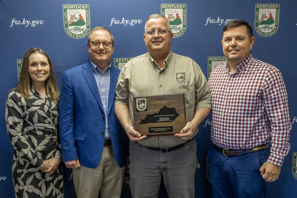 Pictured left to right Information and Education Division Assistant Director Emily Hogue, Information and Education Division Director Kevin Kelly, Kevin Osborne, and Commissioner Rich Storm.