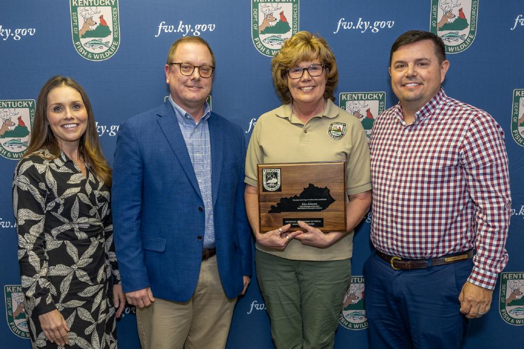 Pictured left to right Information and Education Division Assistant Director Emily Hogue, Information and Education Division Director Kevin Kelly, Lisa Johnson, and Commissioner Rich Storm.