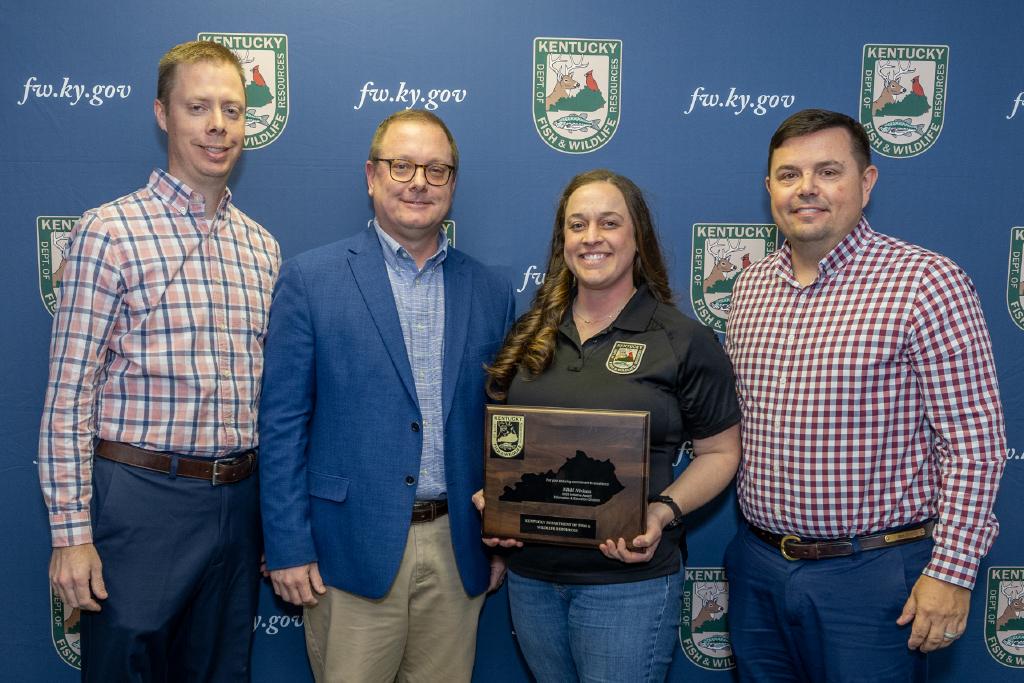 Pictured Information and Education Division Assistant Director Nathan Brooks, Information and Education Division Director Kevin Kelly, Nikki Nivison, and Commissioner Rich Storm.