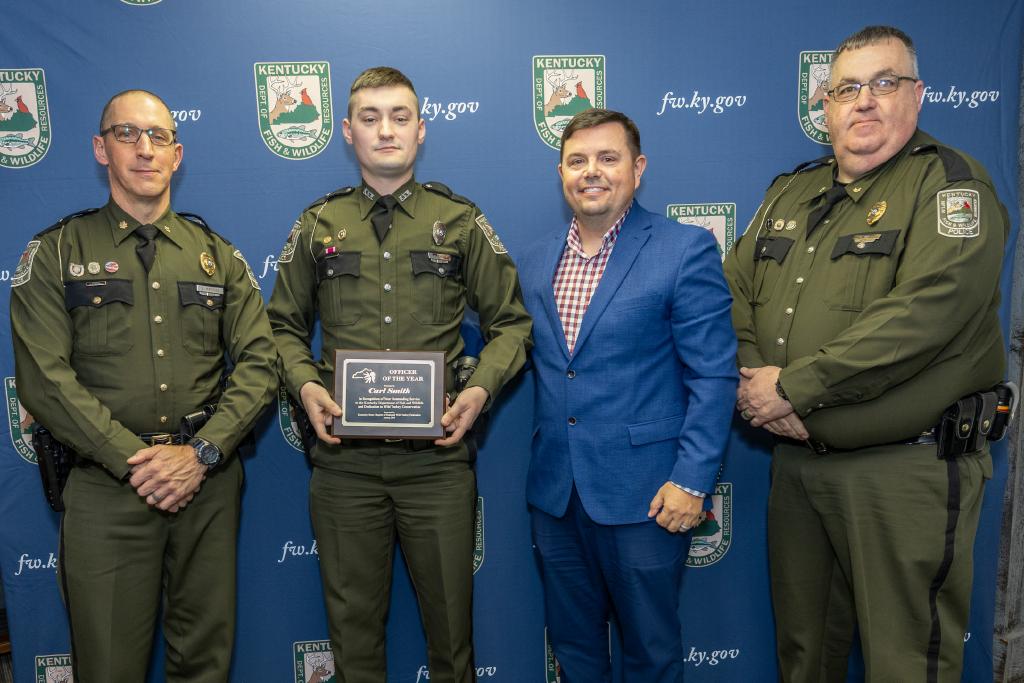 Pictured left to right Law Enforcement Division Assistant Director Maj. David Marques, Ofc. Carl Smith, Jr., Commissioner Rich Storm, and Law Enforcement Division Assistant Director Maj. Greg Watts