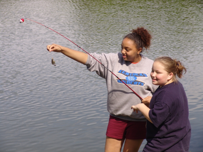 Two girls are helping each other fish
