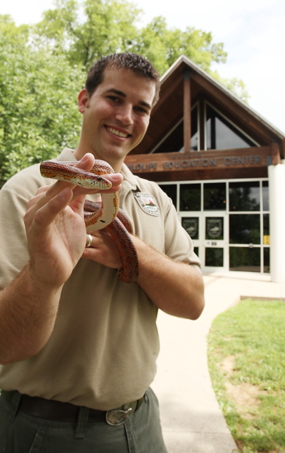 Fish and Wildlife employee holding snake in front of Salato
